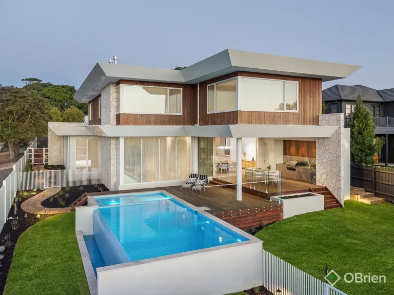 Aerial view of luxury Mornington home with large sliding aluminium doors and pool