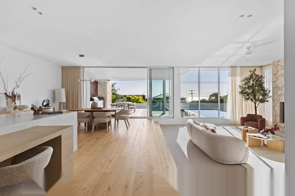 Open plan living with floor-to-ceiling aluminium sliding doors and fixed windows