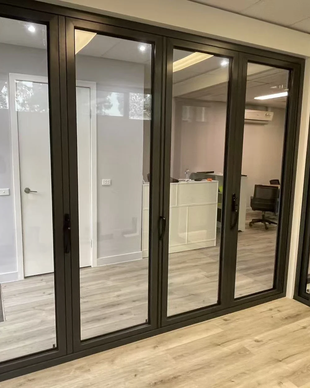 Black aluminium multi-panel folding door display at the Iconic Windows showroom