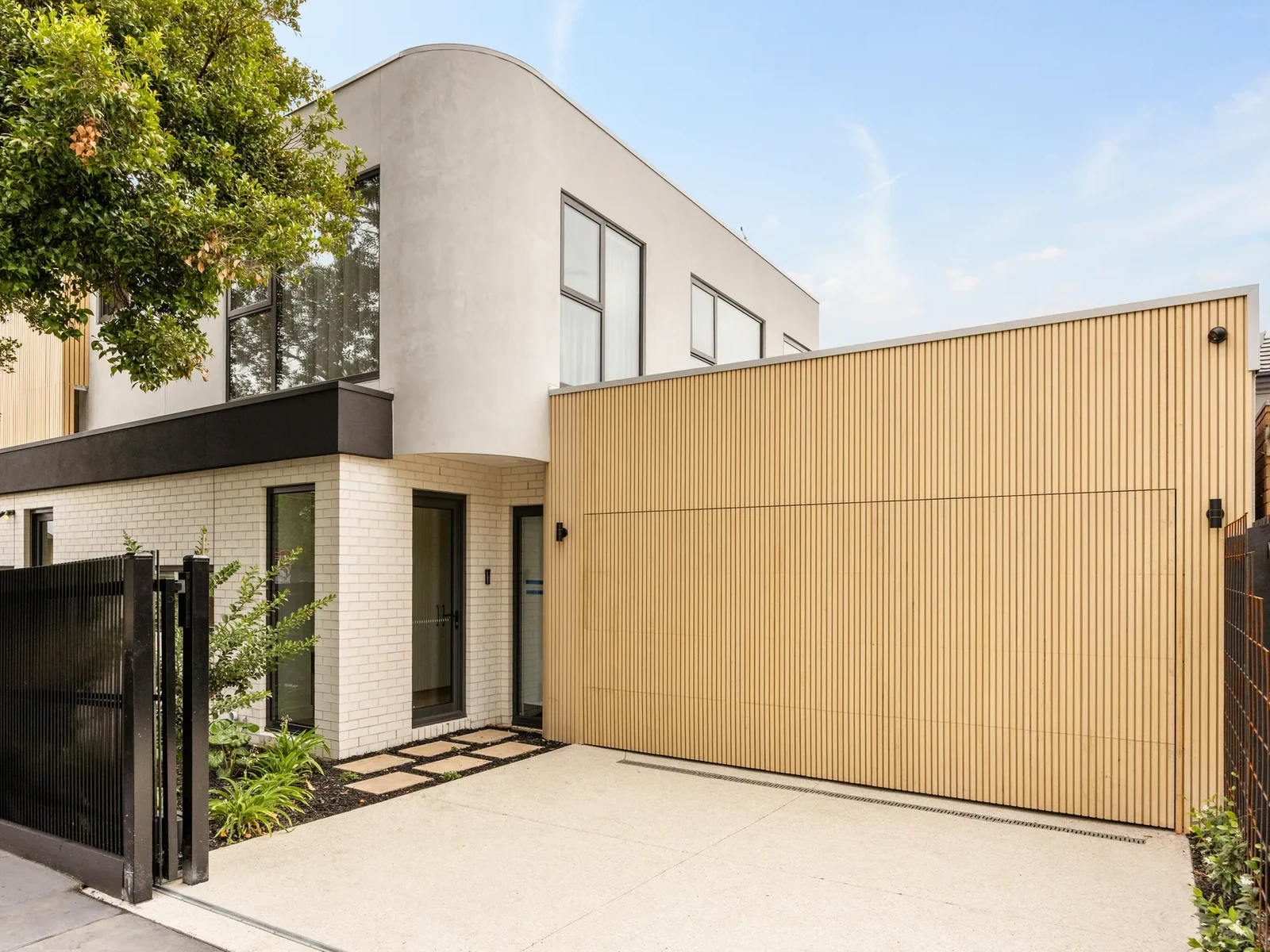 Completed Ashburton rear elevation with black aluminium windows and glazed doors