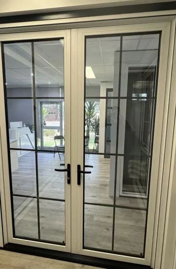 White aluminium French doors with glazed panels at the Iconic Windows showroom